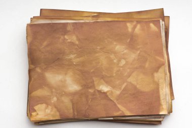 Aged paper sheet. Blank old background with dust and dirty stains. Vintage and antique art concept. Poster mockup. Detailed closeup studio shot. Front view. Toned