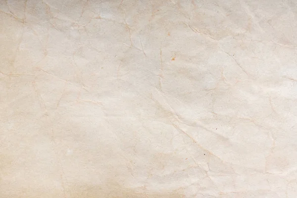 Aged paper sheet. Blank old background with dust and dirty stains. Vintage and antique art concept. Poster mockup. Detailed closeup studio shot. Front view. Toned