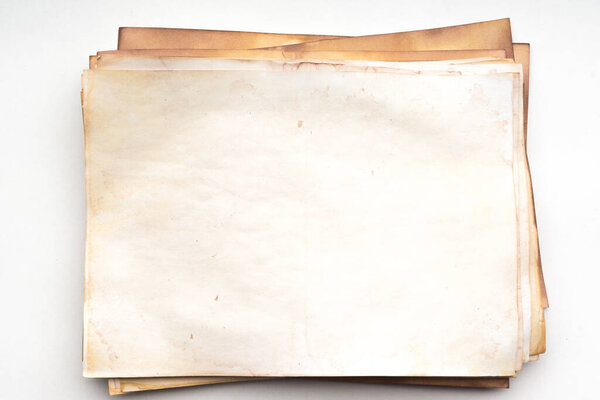 Aged paper sheet. Blank old background with dust and dirty stains. Vintage and antique art concept. Poster mockup. Detailed closeup studio shot. Front view. Toned