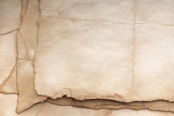 Aged paper sheet. Blank old background with dust and dirty stains. Vintage and antique art concept. Poster mockup. Detailed closeup studio shot. Front view. Toned