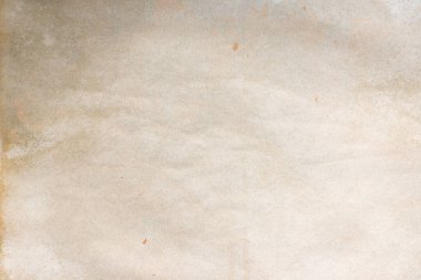Aged paper sheet. Blank old background with dust and dirty stains. Vintage and antique art concept. Poster mockup. Detailed closeup studio shot. Front view. Toned