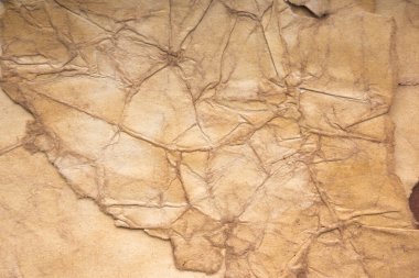 Aged paper sheet. Blank old background with dust and dirty stains. Vintage and antique art concept. Poster mockup. Detailed closeup studio shot. Front view. Toned