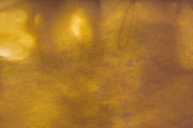 Aged paper sheet. Blank old background with dust and dirty stains. Vintage and antique art concept. Poster mockup. Detailed closeup studio shot. Front view. Toned