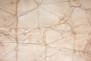 Aged paper sheet. Blank old background with dust and dirty stains. Vintage and antique art concept. Poster mockup. Detailed closeup studio shot. Front view. Toned