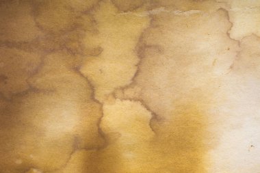 Aged paper sheet. Blank old background with dust and dirty stains. Vintage and antique art concept. Poster mockup. Detailed closeup studio shot. Front view. Toned