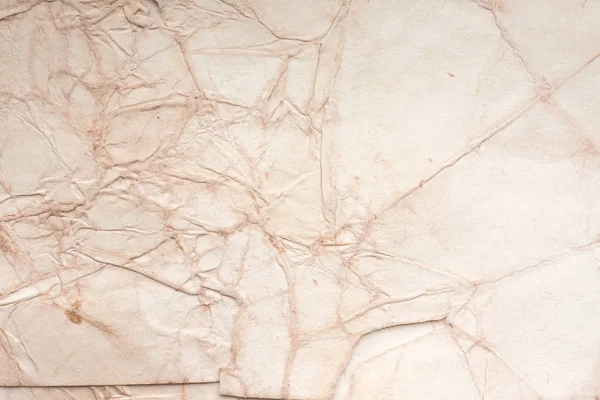 Aged paper sheet. Blank old background with dust and dirty stains. Vintage and antique art concept. Poster mockup. Detailed closeup studio shot. Front view. Toned