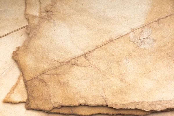 Aged paper sheet. Blank old background with dust and dirty stains. Vintage and antique art concept. Poster mockup. Detailed closeup studio shot. Front view. Toned