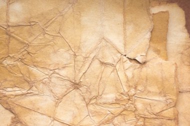 Aged paper sheet. Blank old background with dust and dirty stains. Vintage and antique art concept. Poster mockup. Detailed closeup studio shot. Front view. Toned