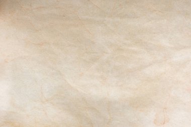 Aged paper sheet. Blank old background with dust and dirty stains. Vintage and antique art concept. Poster mockup. Detailed closeup studio shot. Front view. Toned