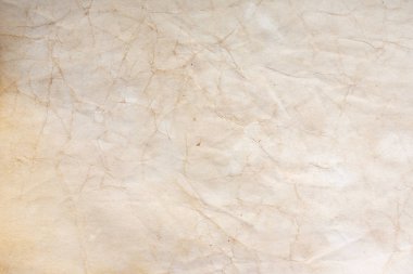 Aged paper sheet. Blank old background with dust and dirty stains. Vintage and antique art concept. Poster mockup. Detailed closeup studio shot. Front view. Toned