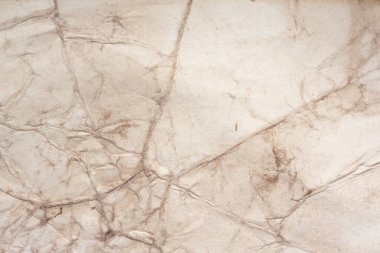 Aged paper sheet. Blank old background with dust and dirty stains. Vintage and antique art concept. Poster mockup. Detailed closeup studio shot. Front view. Toned