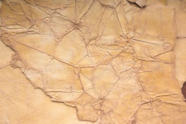 Aged paper sheet. Blank old background with dust and dirty stains. Vintage and antique art concept. Poster mockup. Detailed closeup studio shot. Front view. Toned