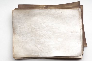 Aged paper sheet. Blank old background with dust and dirty stains. Vintage and antique art concept. Poster mockup. Detailed closeup studio shot. Front view. Toned