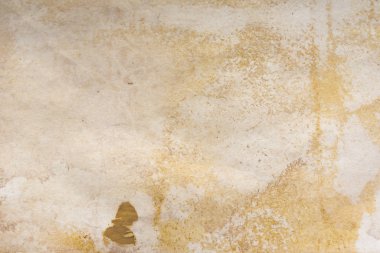 Aged paper sheet. Blank old background with dust and dirty stains. Vintage and antique art concept. Poster mockup. Detailed closeup studio shot. Front view. Toned