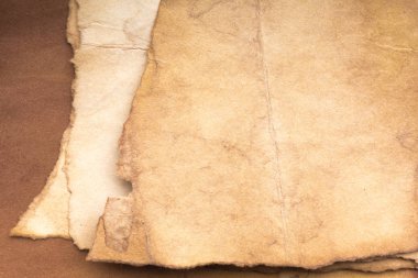 Aged paper sheet. Blank old background with dust and dirty stains. Vintage and antique art concept. Poster mockup. Detailed closeup studio shot. Front view. Toned