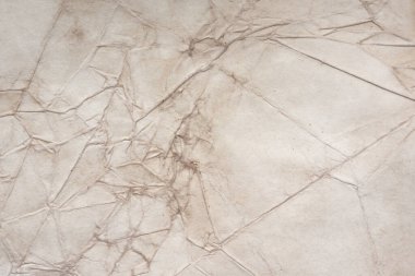 Aged paper sheet. Blank old background with dust and dirty stains. Vintage and antique art concept. Poster mockup. Detailed closeup studio shot. Front view. Toned