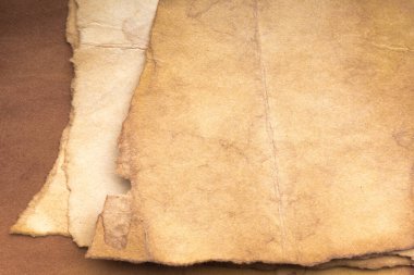 Aged paper sheet. Blank old background with dust and dirty stains. Vintage and antique art concept. Poster mockup. Detailed closeup studio shot. Front view. Toned