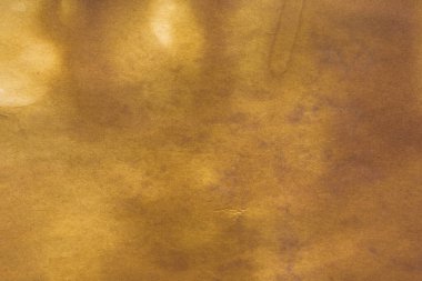 Aged paper sheet. Blank old background with dust and dirty stains. Vintage and antique art concept. Poster mockup. Detailed closeup studio shot. Front view. Toned
