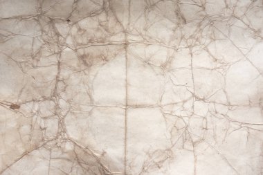 Aged paper sheet. Blank old background with dust and dirty stains. Vintage and antique art concept. Poster mockup. Detailed closeup studio shot. Front view. Toned