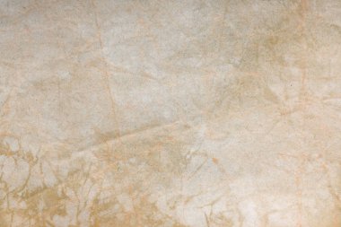 Aged paper sheet. Blank old background with dust and dirty stains. Vintage and antique art concept. Poster mockup. Detailed closeup studio shot. Front view. Toned