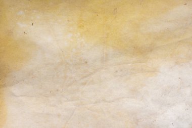 Aged paper sheet. Blank old background with dust and dirty stains. Vintage and antique art concept. Poster mockup. Detailed closeup studio shot. Front view. Toned