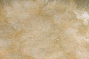 Aged paper sheet. Blank old background with dust and dirty stains. Vintage and antique art concept. Poster mockup. Detailed closeup studio shot. Front view. Toned