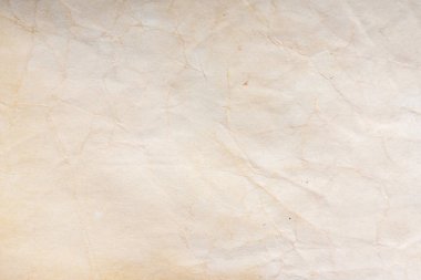 Aged paper sheet. Blank old background with dust and dirty stains. Vintage and antique art concept. Poster mockup. Detailed closeup studio shot. Front view. Toned