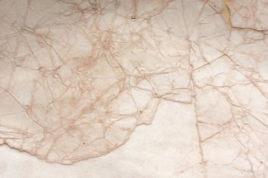 Aged paper sheet. Blank old background with dust and dirty stains. Vintage and antique art concept. Poster mockup. Detailed closeup studio shot. Front view. Toned