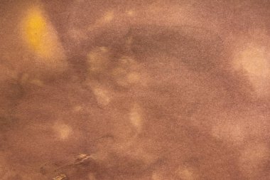 Aged paper sheet. Blank old background with dust and dirty stains. Vintage and antique art concept. Poster mockup. Detailed closeup studio shot. Front view. Toned