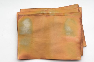 Aged paper sheet. Blank old background with dust and dirty stains. Vintage and antique art concept. Poster mockup. Detailed closeup studio shot. Front view. Toned