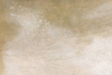 Aged paper sheet. Blank old background with dust and dirty stains. Vintage and antique art concept. Poster mockup. Detailed closeup studio shot. Front view. Toned