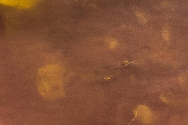 Aged paper sheet. Blank old background with dust and dirty stains. Vintage and antique art concept. Poster mockup. Detailed closeup studio shot. Front view. Toned