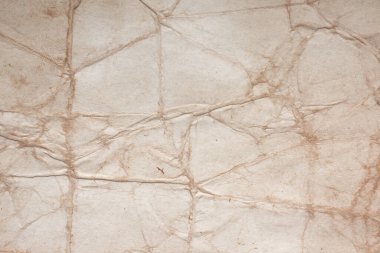 Aged paper sheet. Blank old background with dust and dirty stains. Vintage and antique art concept. Poster mockup. Detailed closeup studio shot. Front view. Toned