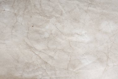 Aged paper sheet. Blank old background with dust and dirty stains. Vintage and antique art concept. Poster mockup. Detailed closeup studio shot. Front view. Toned