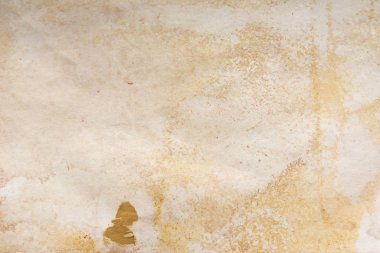Aged paper sheet. Blank old background with dust and dirty stains. Vintage and antique art concept. Poster mockup. Detailed closeup studio shot. Front view. Toned