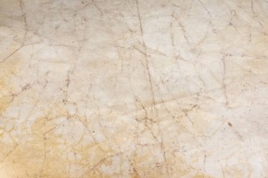 Aged paper sheet. Blank old background with dust and dirty stains. Vintage and antique art concept. Poster mockup. Detailed closeup studio shot. Front view. Toned