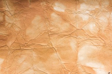Aged paper sheet. Blank old background with dust and dirty stains. Vintage and antique art concept. Poster mockup. Detailed closeup studio shot. Front view. Toned