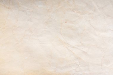 Aged paper sheet. Blank old background with dust and dirty stains. Vintage and antique art concept. Poster mockup. Detailed closeup studio shot. Front view. Toned
