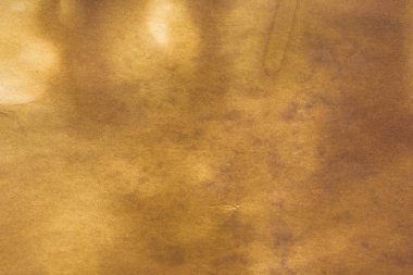 Aged paper sheet. Blank old background with dust and dirty stains. Vintage and antique art concept. Poster mockup. Detailed closeup studio shot. Front view. Toned