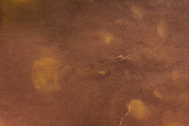 Aged paper sheet. Blank old background with dust and dirty stains. Vintage and antique art concept. Poster mockup. Detailed closeup studio shot. Front view. Toned