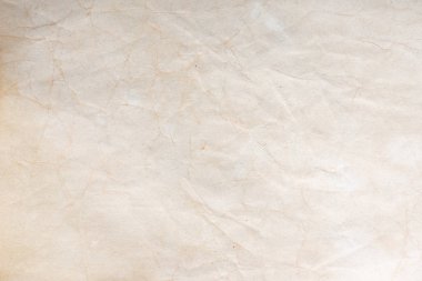 Aged paper sheet. Blank old background with dust and dirty stains. Vintage and antique art concept. Poster mockup. Detailed closeup studio shot. Front view. Toned