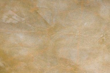 Aged paper sheet. Blank old background with dust and dirty stains. Vintage and antique art concept. Poster mockup. Detailed closeup studio shot. Front view. Toned