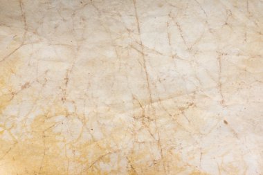 Aged paper sheet. Blank old background with dust and dirty stains. Vintage and antique art concept. Poster mockup. Detailed closeup studio shot. Front view. Toned