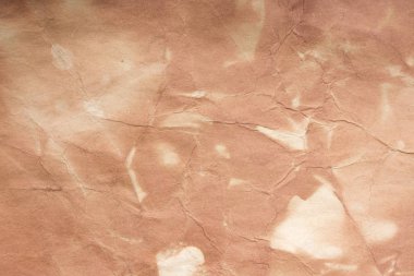 Aged paper sheet. Blank old background with dust and dirty stains. Vintage and antique art concept. Poster mockup. Detailed closeup studio shot. Front view. Toned