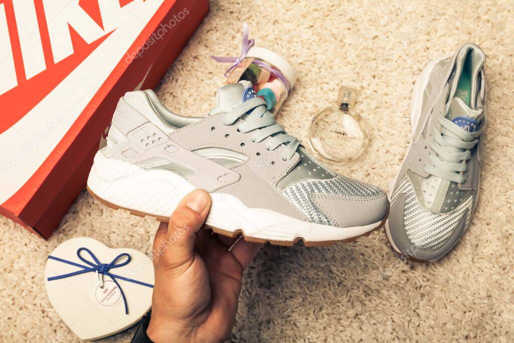 New beautiful colorful and nice Nike Air Huarache running shoes, sneakers, trainers showing logo with a brand box on abstract background. Sport and casual footwear concept. Kyiv, Ukraine-May 15, 2018