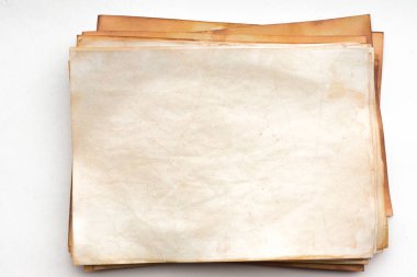 Aged paper sheet. Blank old background with dust and dirty stains. Vintage and antique art concept. Poster mockup. Detailed closeup studio shot. Front view. Toned