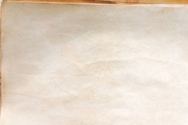Aged paper sheet. Blank old background with dust and dirty stains. Vintage and antique art concept. Poster mockup. Detailed closeup studio shot. Front view. Toned