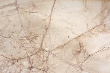 Aged paper sheet. Blank old background with dust and dirty stains. Vintage and antique art concept. Poster mockup. Detailed closeup studio shot. Front view. Toned