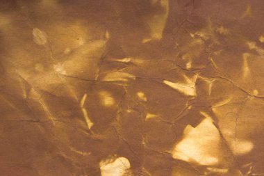 Aged paper sheet. Blank old background with dust and dirty stains. Vintage and antique art concept. Poster mockup. Detailed closeup studio shot. Front view. Toned