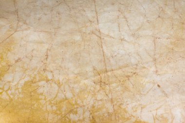 Aged paper sheet. Blank old background with dust and dirty stains. Vintage and antique art concept. Poster mockup. Detailed closeup studio shot. Front view. Toned